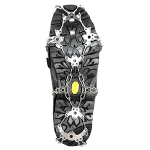 Metal traction cleats attached to the sole of a black hiking boot
