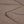 Close up of brown fabric showing stitched hem detail
