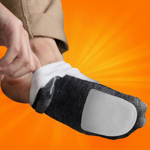Person putting on a grey sock with a white adhesive patch on the sole