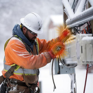 Utility worker in high visibility gear and hard hat working on equipment during a snowstorm
