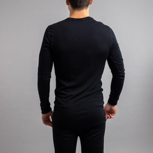 Back view of a man wearing a black Merino Skins long sleeve thermal top