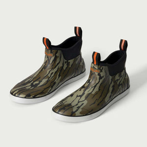 Huk camo ankle boots with white soles and orange pull tabs