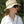 Person wearing a beige HyperKewl cooling bucket hat with chin strap and sunglasses