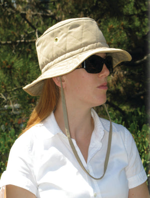 Person wearing a beige HyperKewl cooling bucket hat with chin strap and sunglasses