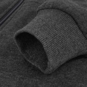 Close up of a dark grey fleece jacket sleeve with a ribbed cuff
