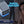 Ontel Arctic Air portable cooler with blue night light on a bedside table next to a sleeping person