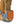 Winter Walking ice cleat attached to the heel of a tan boot