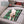Zone Tech green plaid polar fleece pet heating pad on a car seat with a small dog lying on it
