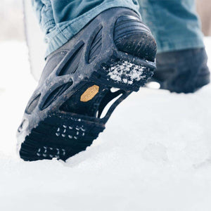 Impacto ice traction cleat on a boot sole walking in snow