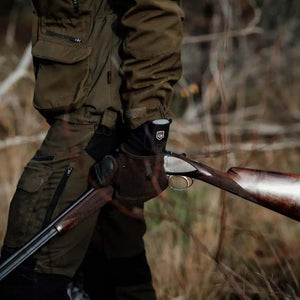 Person wearing Arctic Volt outdoor gear holding a shotgun