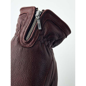 Close up of a dark brown Hestra leather glove cuff with a metal zipper