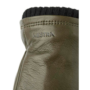 Olive green Hestra leather glove with black ribbed cuff