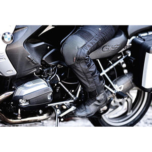 Rider wearing Gerbing black textile motorcycle pants with knee armor on a BMW GS motorcycle