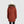 Back view of a person wearing an Outdoor Research rust colored hooded parka with faux fur trim and a white beanie