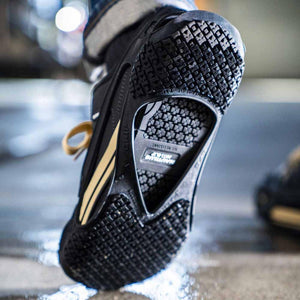 K1 Ice Cleats traction device attached to the sole of a work boot