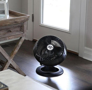 Black Vornado air circulator fan on a wooden floor