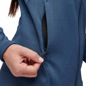 Close up of a hand opening the zippered pocket on a blue Black Diamond fleece jacket
