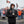 Man wearing ActionHeat black heated jacket and gloves holding a steaming cup at a Cleveland Browns tailgate