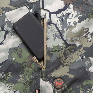 Black power bank inside a zippered pocket of a camouflage patterned Ultra jacket