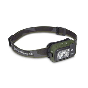 Black Diamond Storm headlamp with olive green casing and camouflage patterned strap