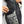 Person placing a smartphone into the interior chest pocket of a black jacket