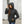 Woman wearing a black Kelvin hooded softshell jacket