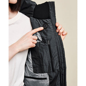 Person pressing the power button on the interior of a Kelvin heated jacket