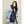 Kelvin distressed denim jacket layered over a black puffer vest