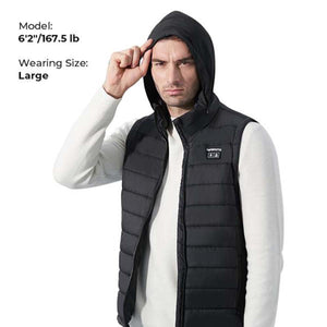 Man wearing a black Kemimoto heated vest with hood over a white sweater