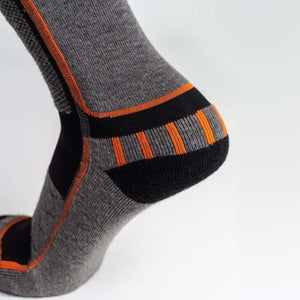 Mobile Warming grey and black performance sock with orange accents on the heel and ankle