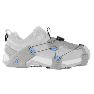 Korkers grey traction cleat attached to a white shoe with a dial lacing system
