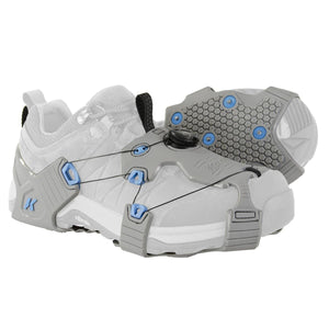 Korkers grey traction cleats with dial lacing system attached to a white shoe
