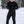 Man wearing Gobi Heat black heated base layer top and pants in a snowy outdoor setting