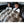 Two children sitting in a car backseat covered by a faux fur throw blanket