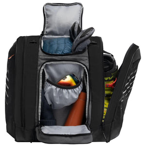 Open black ski boot bag with packed winter gear and ski boots