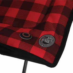 Kuma Outdoor Gear heated chair power button and logo patch on red and black plaid fabric
