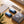 Ocoopa rechargeable hand warmers with charging cables, storage pouch, and user manual on a wooden surface