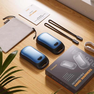 Ocoopa rechargeable hand warmers with charging cables, storage pouch, and user manual on a wooden surface