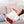 Person wearing a UTK Technology infrared heating pad on their forearm while resting on a sofa