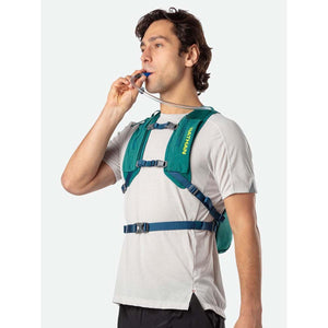 Man wearing a green Nathan hydration vest and drinking from the tube