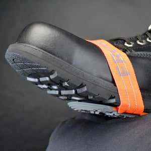 Winter Walking ice cleat attached to the sole of a black work boot