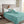 Beautyrest teal plush electric blanket draped over a person reading in bed