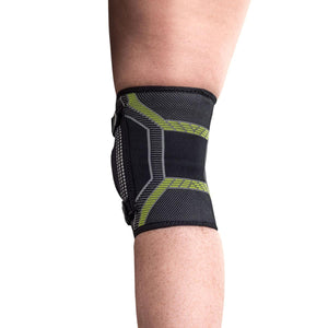 Black and neon green compression knee brace worn on a leg