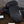 Seirus HeatTouch Hellfire black heated mittens with battery pack on wooden surface
