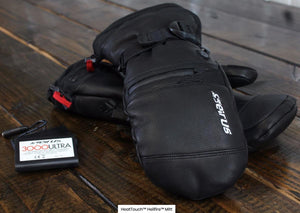 Seirus HeatTouch Hellfire black heated mittens with battery pack on wooden surface