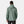 Back view of a man wearing a sage green Helly Hansen hooded rain jacket