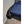 Black portable bed cooling unit with flexible air hose directed onto a blue bedspread