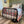 Mattress Cooler unit connected to a bed with a patterned quilt and black metal frame