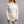 Woman wearing a Merino Skins cream long sleeve crew neck thermal top