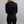 Back view of a person wearing a black long sleeve shirt with a collar